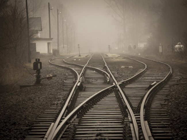 Image shows railway tracks and junction in fog with a sepia tint applied to the photograph