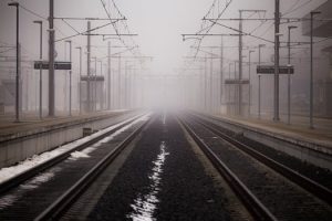 Train station and railway tracks in fog