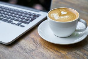 Working in a cafe with a laptop computer and coffee