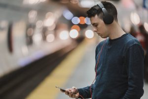 Man listening to audio on london underground
