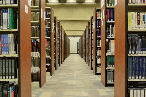 Image shows library shelves in a row