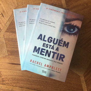 Image shows three print copies of The Friend Who Lied Portuguese translation Alguem esta a Mentir stacked on top of each other face up