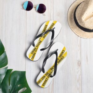 Image shows white flip flops (thongs) with black straps and yellow crime scene tape printed on the uppers