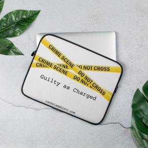 Laptop cover with yellow crime scene tape and text Guilty as Charged