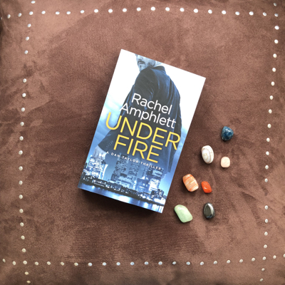 Under Fire book resting on a plush brown velvet background