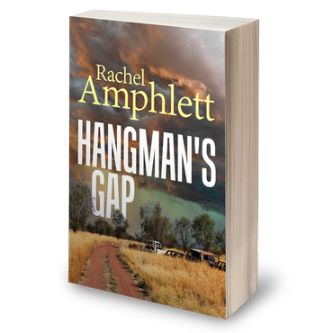 hangman's gap book cover illustrating a small town dirt road under a dark stormy sky, wit rusty old cars strewn across the fields to the side of the road.