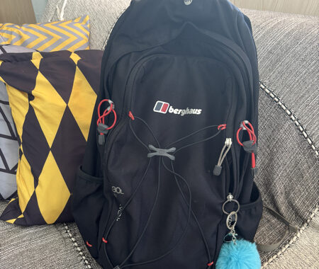 Backpack with a blue fluffy keyring