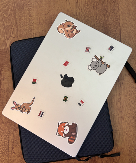 Laptop with country flags and animal stickers Laptop decorated country flags and animal stickers